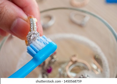 Jeweller Hand Cleaning And Polishing Vintage Jewelry Diamond Ring Closeup