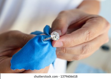 Jeweller hand polishing   cleaning jewelry diamond ring and micro fiber fabric
