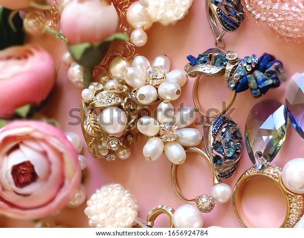  Jewelry background  Gold white pearl rings\
earrings bracelet blue crystal stone with red and pink roses\
floral,  fashion women\
accessories