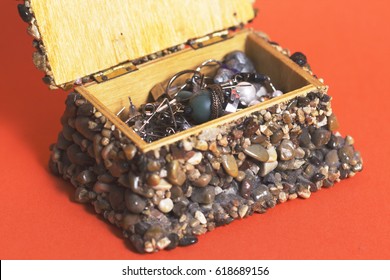 Jewelry box made from wood and jackstone, orange background