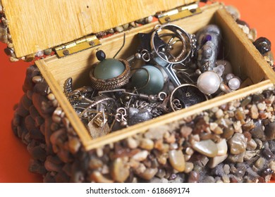 Jewelry box made from wood and jackstone, orange background