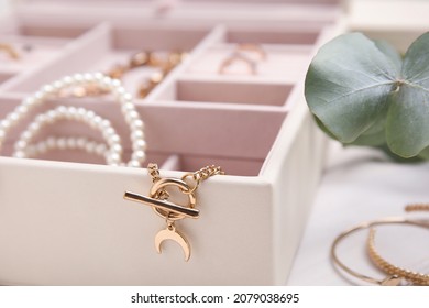 Jewelry box with stylish golden bijouterie on white table, closeup - Shutterstock ID 2079038695
