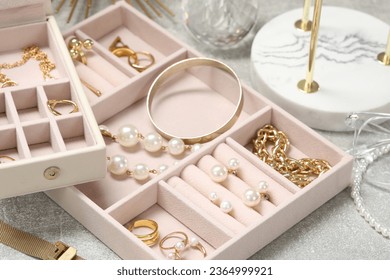 Jewelry boxes with many different accessories on light grey table, closeup - Shutterstock ID 2364999921