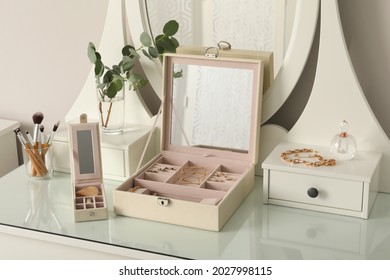 Jewelry boxes and stylish golden bijouterie white dressing table