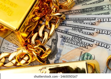 Jewelry Buyer, Pawn Shop And Buy And Sell Precious Metals Concept Theme With A Pile Of Cash In US Dollars, Golden Rings, Necklace Bracelet And Gold Bullion Isolated On White Background