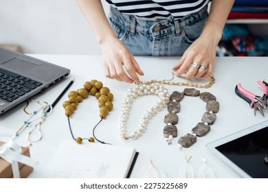 Jewelry Design: Learn the art of designing jewelry, including sketching, selecting materials, and creating prototypes. Female designer makes and design jewelry in workshop - Shutterstock ID 2275225689
