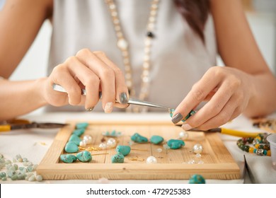 Jewelry designer using pliers in her work