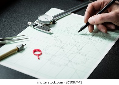 Jewelry designer works on a hand drawing sketch of the ring.