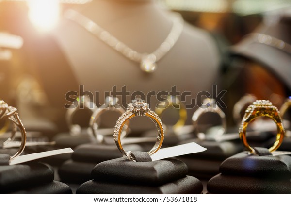 Jewelry diamond rings and necklaces show\
in luxury retail store window display\
showcase