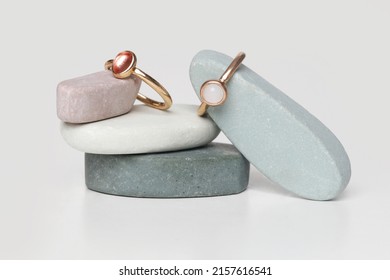 Jewelry Fashion Photography. Costume Jewelry Rings Displayed On Decorative Oval Stones, Studio Product Shot.