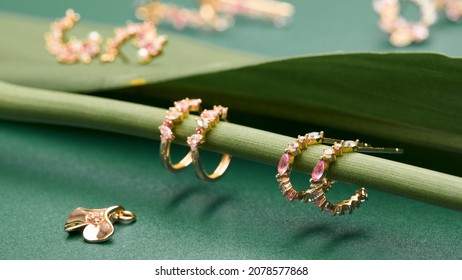 Jewelry fashion photography. Earrings on a green leaf texture. content creative minimalist shooting.