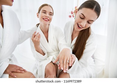 Jewelry From Fiance. Beautiful Young Women In White Bathrobes Having Bachelorette Party At Spa Salon