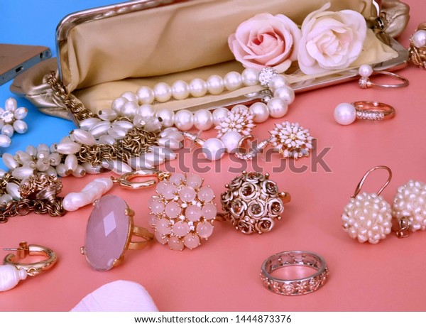  Jewelry\
gold  white pearl Luxury Glamour fashion  costume jewelry cosmetics\
cases  rings earrings bracelet with \
 red roses on blue and pink\
coral background women accessories\
