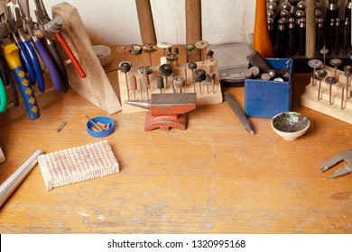 Jewelry Maker Workbench With Tools On Table. Equipment And Tools Of A Goldsmith On Wooden Working Desk Inside A Workshop.