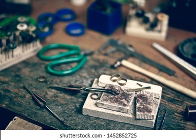 Jewelry Maker Workbench With Tools On Table. Equipment And Tools Of A Goldsmith On Wooden Working Desk Inside A Workshop.