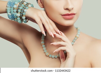 Jewelry on female hand. Natural color nails, pink lips and blue bracelet - Shutterstock ID 1132443422