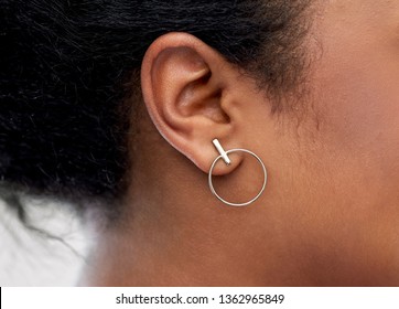 Jewelry, Piercing And People Concept - Close Up Of African American Woman Ear With Silver Earring