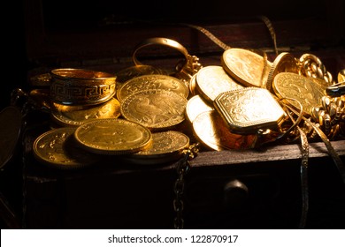 Jewels And Gold Coins Over Dark Background