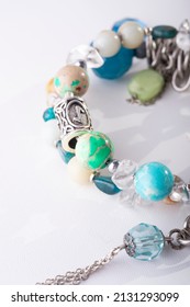 jewerly bracelet with semiprecious stones around  white background. top view. macro shot