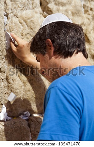 Similar – Little boy looking through the wall of a castle