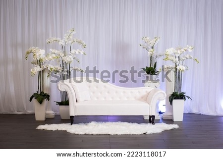 Jewish bride wedding chair, chuppah at wedding day ceremony. Flowers and  vases with chaise lounge.