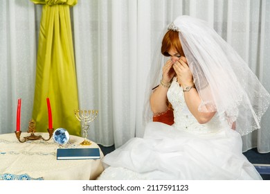 The Jewish Bride Wipes Her Tears Before The Hupa Ceremony In A Wedding Dress Does Not Want To Get Married. Horizontal Photo