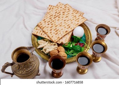 Jewish family celebrating passover, matzoh jewish holiday bread with kiddush four cup of wine