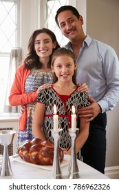 Jewish Family Smile To Camera Before Shabbat Meal, Vertical