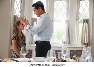 Jewish Father Blesses Daughter By Table Set For Shabbat Meal