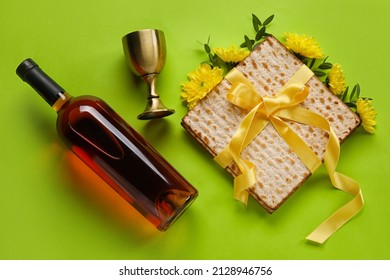 Jewish flatbread with goblet and bottle of wine on color background - Shutterstock ID 2128946756