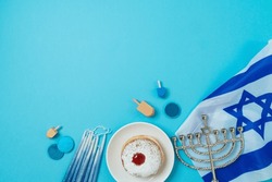 Jewish Holiday Hanukkah Concept With Traditional Donuts, Menorah And Israel Flag On Blue Background. Top View, Flat Lay