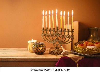 Jewish Holiday Hanukkah Concept With Vintage Menorah, Sufganiyah And Books On Wooden Table