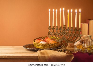 Jewish Holiday Hanukkah Concept With Vintage Menorah, Sufganiyah And Books On Wooden Table