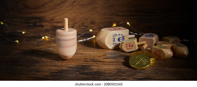 Jewish holiday Hanukkah with wooden dreidels, spinning top