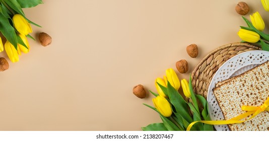 Jewish Holiday Passover Celebration Concept With Matzah, Seder Plate And Yellow Tulip Flowers On Modern Background. Pesah Top View Frame Border Design With Copy Space