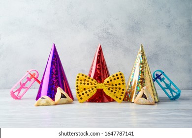 Jewish Holiday Purim Celebration Background With Party Hats And Hamantaschen Cookies On Wooden Table