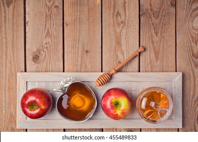 Jewish Holiday Rosh Hashana Background With Honey And Apples On Wooden Table. View From Above. Flat Lay