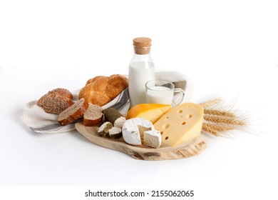 Jewish holiday Shavuot concept with dairy products, cheese, bread, milk bottle on white background