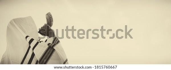 Jewish man\
blowing the Shofar (horn) of Rosh Hashanah (New Year). Religious\
symbol. Old style filter and\
overlay