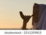 Jewish man blowing the Shofar rams horn on Rosh Hashanah and Yom Kippur day.