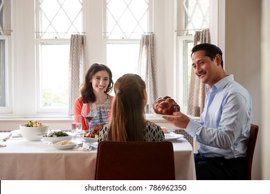 Jewish Man Holding Challah Bread At Shabbat Meal With Family