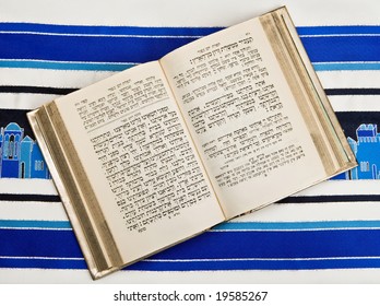 A Jewish Prayer Book, Or Siddur, Open And On Top Of A Jewish Prayer Shawl Or Tallit.