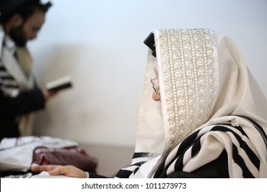 Jewish Rabbi Prays The Morning Prayers With His Tallit And Tefillin In Synagogue