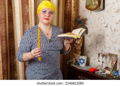 A Jewish Woman In A Kisui Rosh Headdress With A Burning Avdala Candle And A Siddur In Her Hands After Shabbat.. Horizontal Photo