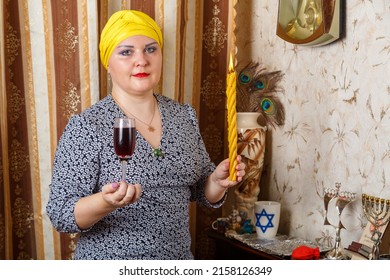 A Jewish Woman In A Kisui Rosh Headdress With A Burning Candle Of Avdala And A Glass Of Wine In Her Hands. Horizontal Photo