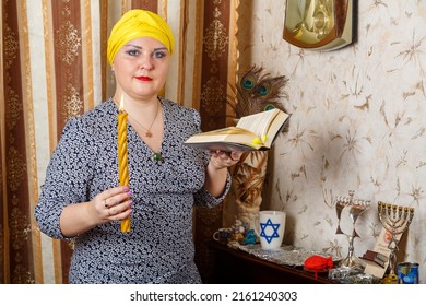 A Jewish Woman In A Kisui Rosh Headdress With A Burning Avdala Candle And A Siddur In Her Hands After Shabbat Horizontal Photo