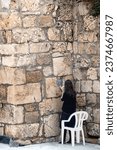 A Jewish woman prays at the Western Wall during Yom Kippur. In Jerusalem, Israel. Palestine-Israel Conflict