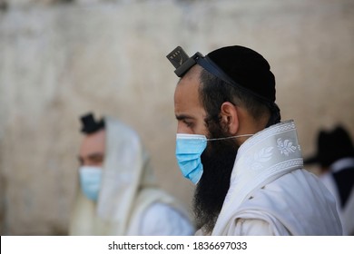 Jewish worshipers pray at the separation partitions in front of the Western Wall in the Old City of Jerusalem,Israel on October 19, 2020, after a one-month lockdown in response to coronavirus. 