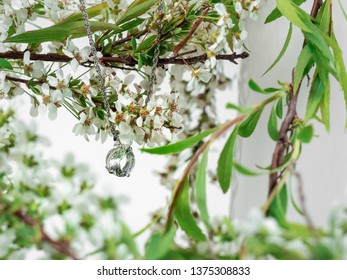 Jewlery Elements Diamond Crystal Necklace On Pure White Background With White Spring Flower With Light Green Leaves On A Light Pink Vase.