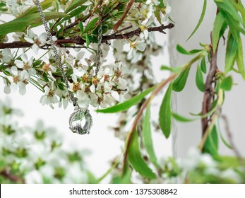 Jewlery Elements Diamond Crystal Necklace On Pure White Background With White Spring Flower With Light Green Leaves On A Light Pink Vase.